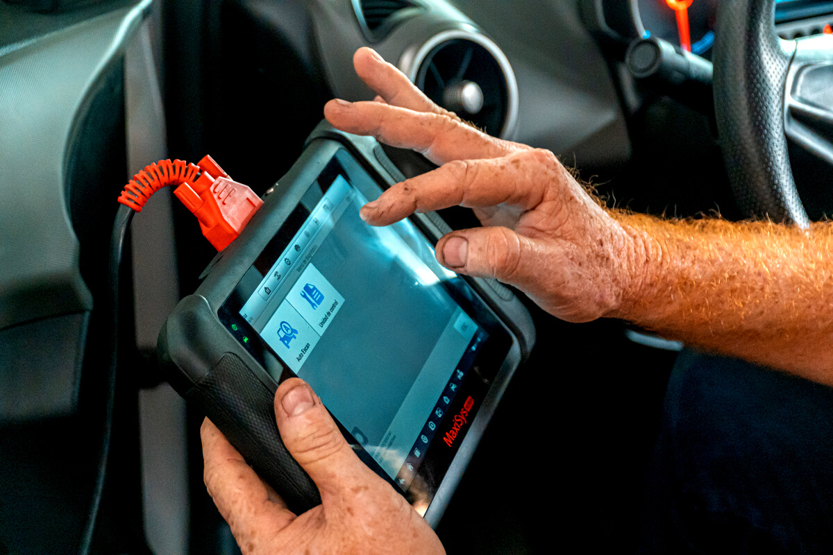 Person Holding Blue Diagnostic Tool